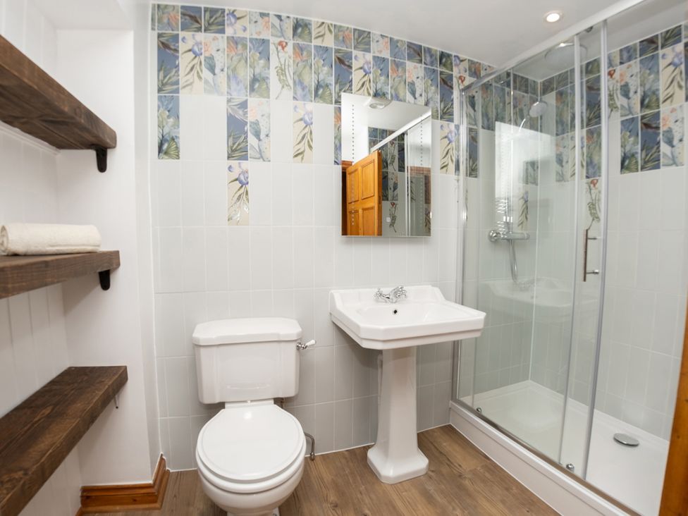 A bathroom with toilet, sink, and shower at Watermouth Castle, Bassett Apartment Berrynarbor near Ilfracombe
