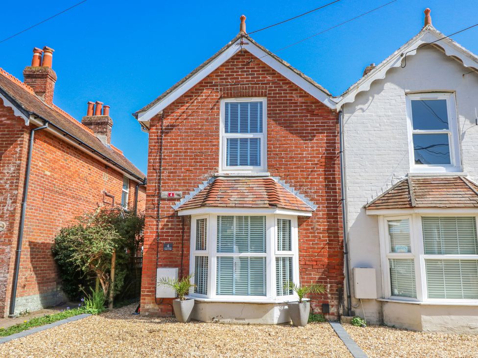 A house exterior with windows and gravel pathway at 4 Copse Lane Freshwater