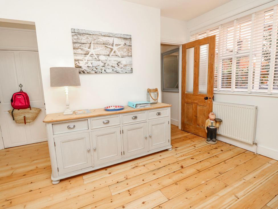 A hallway with a console table and lamp at 4 Copse Lane in Freshwater