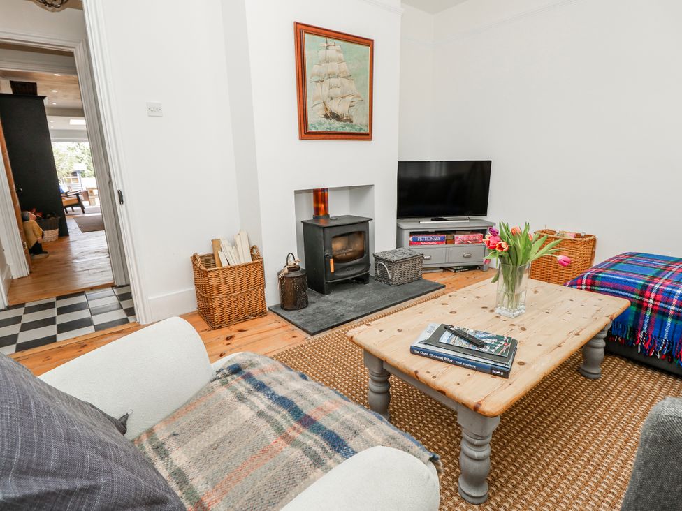 A living room with a fireplace and television at 4 Copse Lane Freshwater