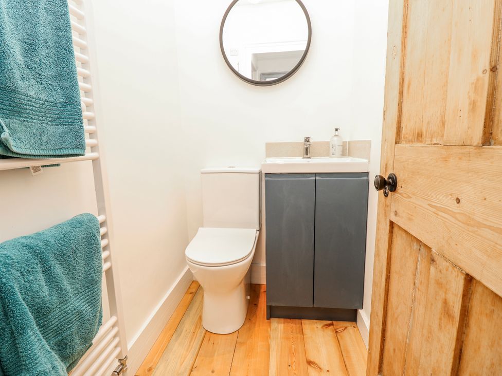 A bathroom with a toilet, sink, and towel rack at 4 Copse Lane Freshwater