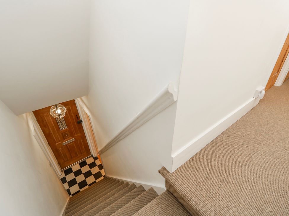 A staircase leading to a door at 4 Copse Lane Freshwater