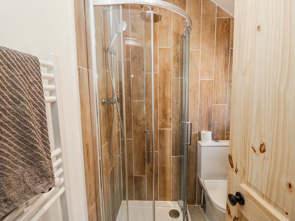 A bathroom with a shower and toilet at 4 Copse Lane Freshwater