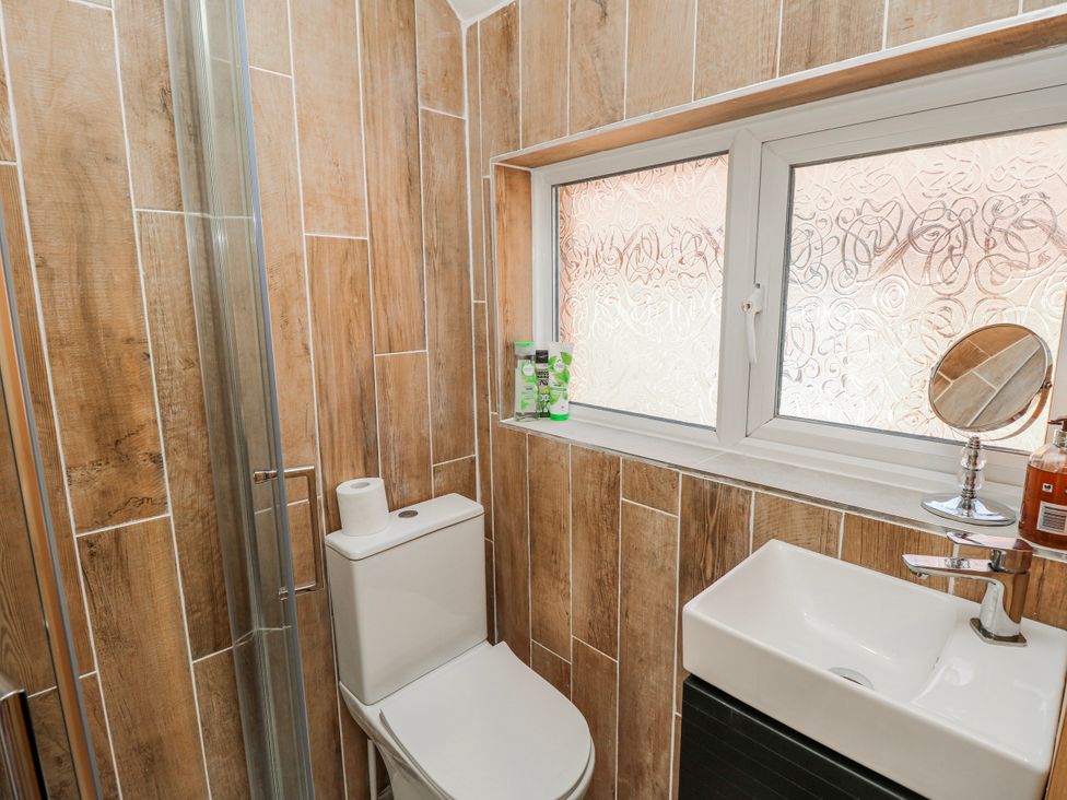 A bathroom with a toilet and sink at 4 Copse Lane in Freshwater