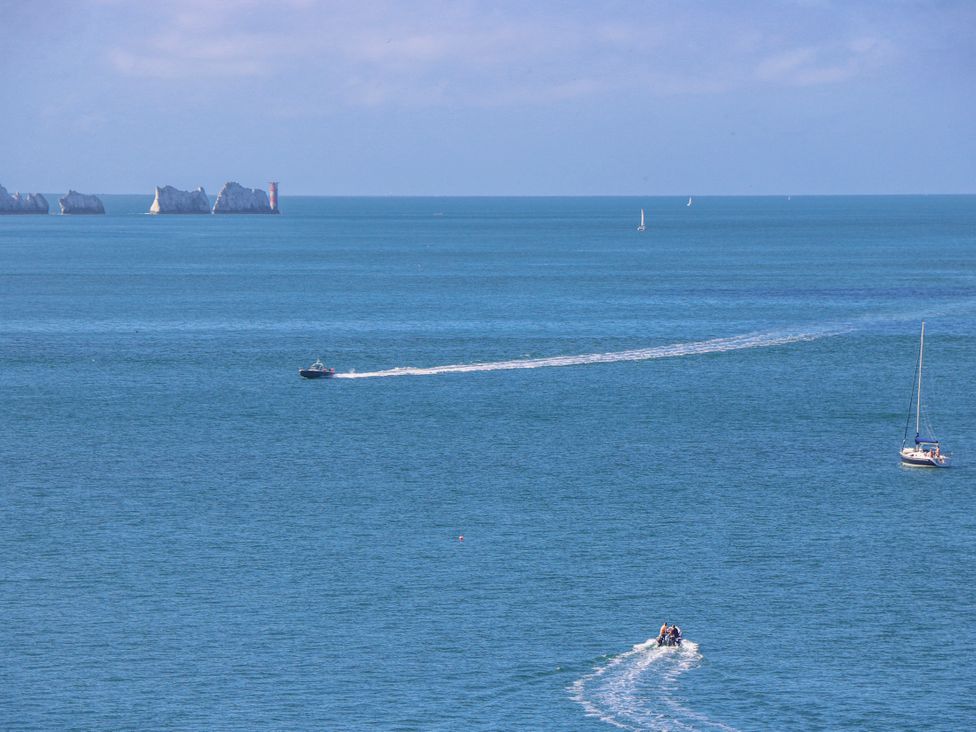 An ocean scene with boats and cliffs at 4 Copse Lane Freshwater