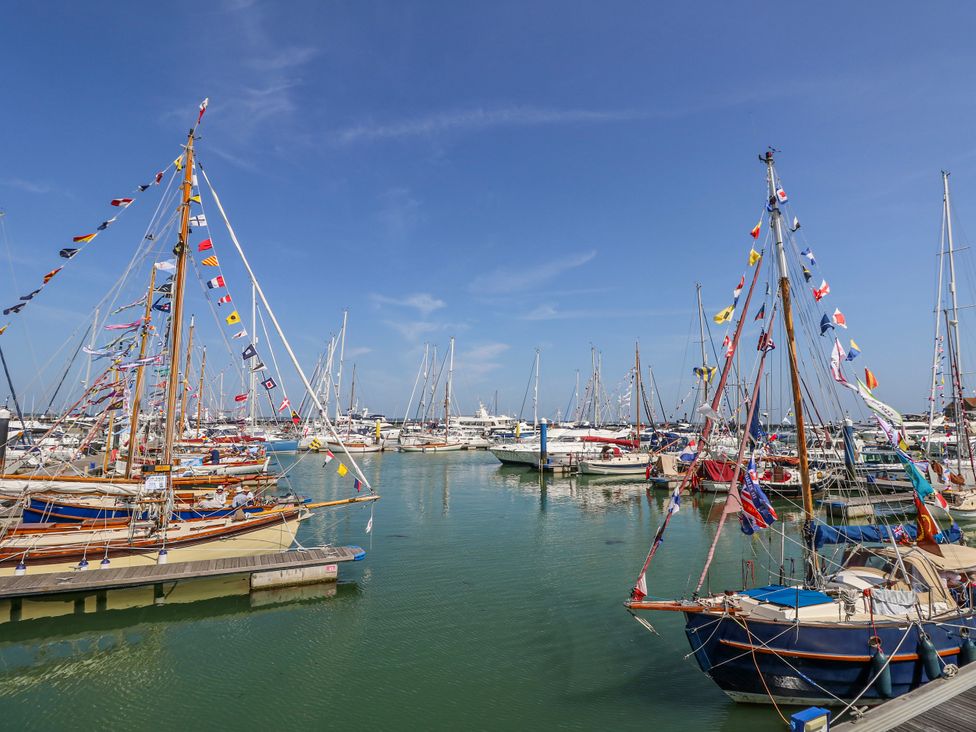 A marina with many boats and colorful flags at 4 Copse Lane Freshwater