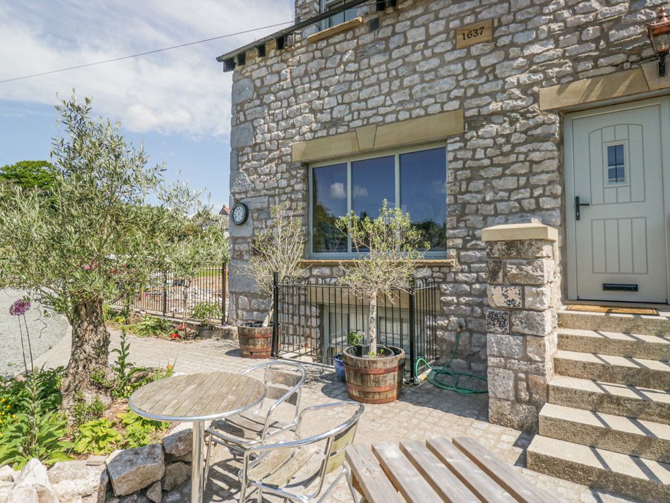 An outdoor area with seating and plants at The Old Watermill in Cartmel
