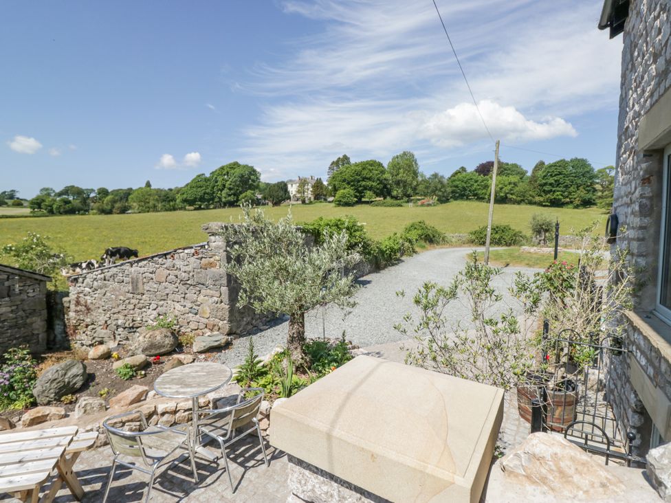 An outdoor area with a table and chairs at The Old Watermill in Cartmel