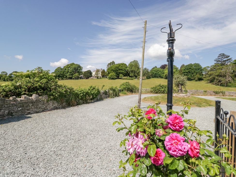 A garden area with gravel and a flower pot at The Old Watermill in Cartmel