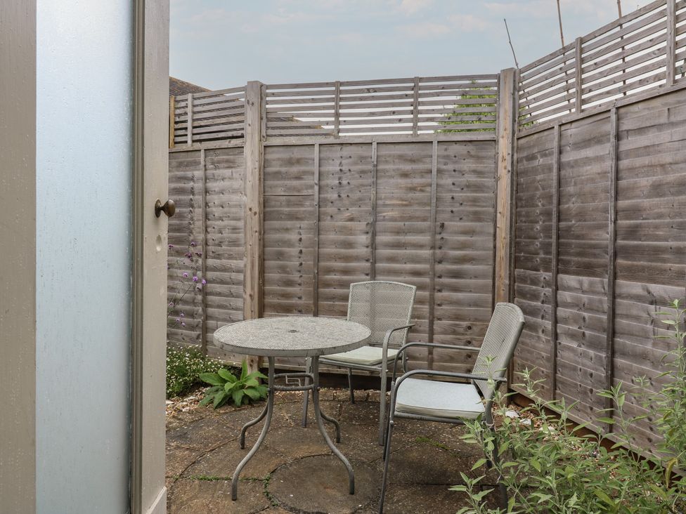 A garden with a table and chairs at The Artist's Cabin By The Sea, Herne Bay