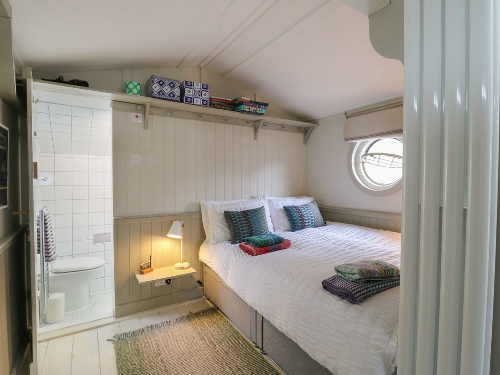 A bedroom with a bed and shower area at The Artist's Cabin By The Sea in Herne Bay