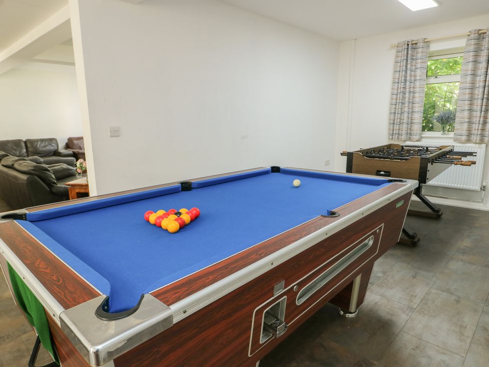 A game room with a pool table and foosball table at The Bevan in Bontnewydd, Gwynedd