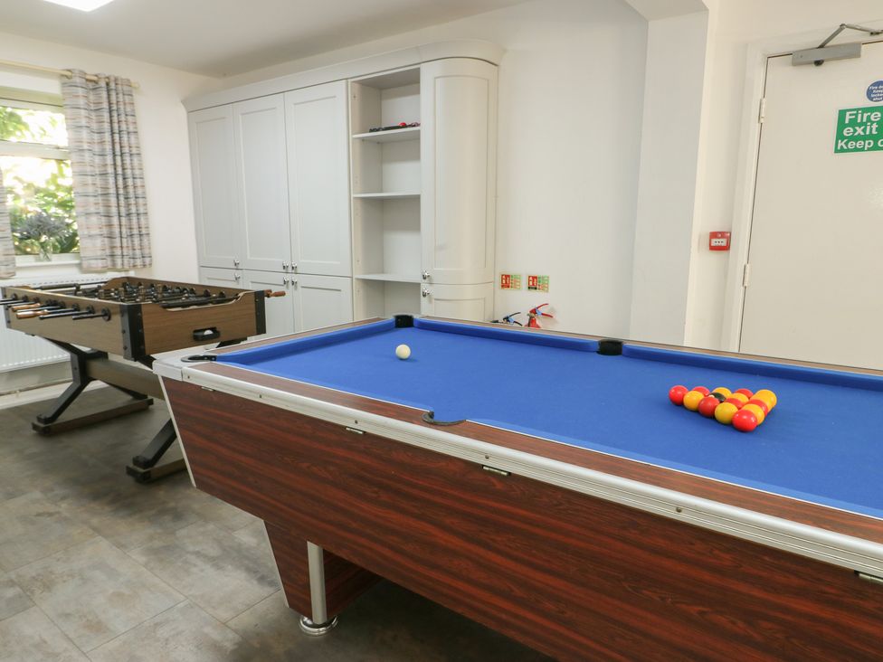 A game room with a pool table and foosball table at The Bevan in Bontnewydd, Gwynedd