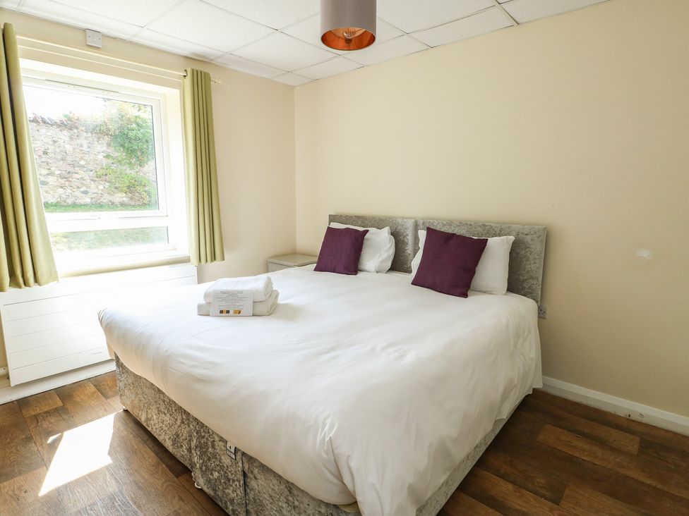 A bedroom with a double bed and window at The Bevan in Bontnewydd, Gwynedd
