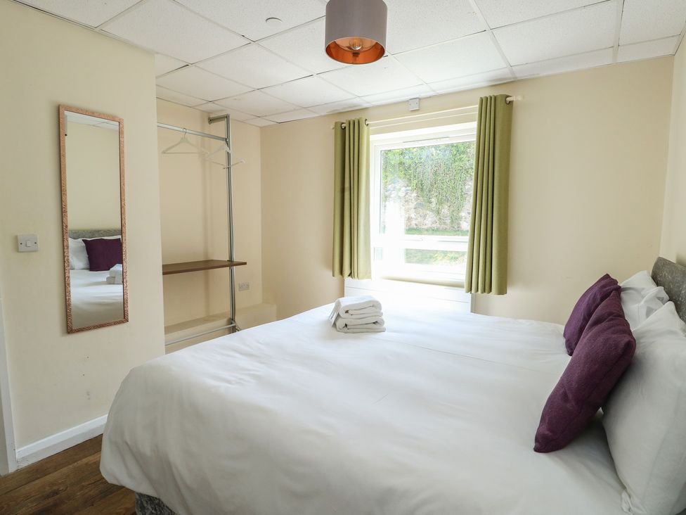 A bedroom with a bed and a window at The Bevan in Bontnewydd, Gwynedd