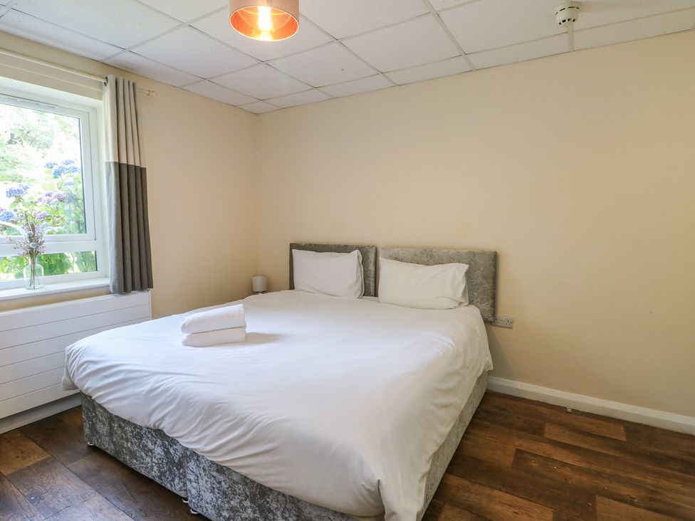 A bedroom with a double bed and window at The Bevan in Bontnewydd, Gwynedd