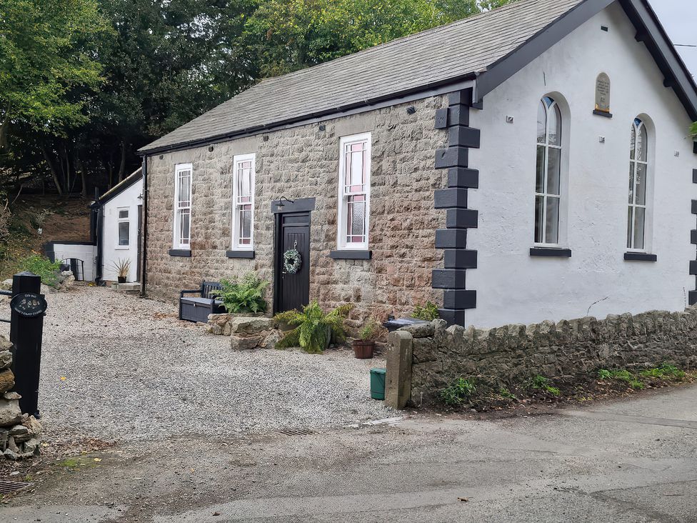 An outdoor view of a building with a pathway at The Old Nant-y-Fflint Chapel Pentre Halkyn near Holywell