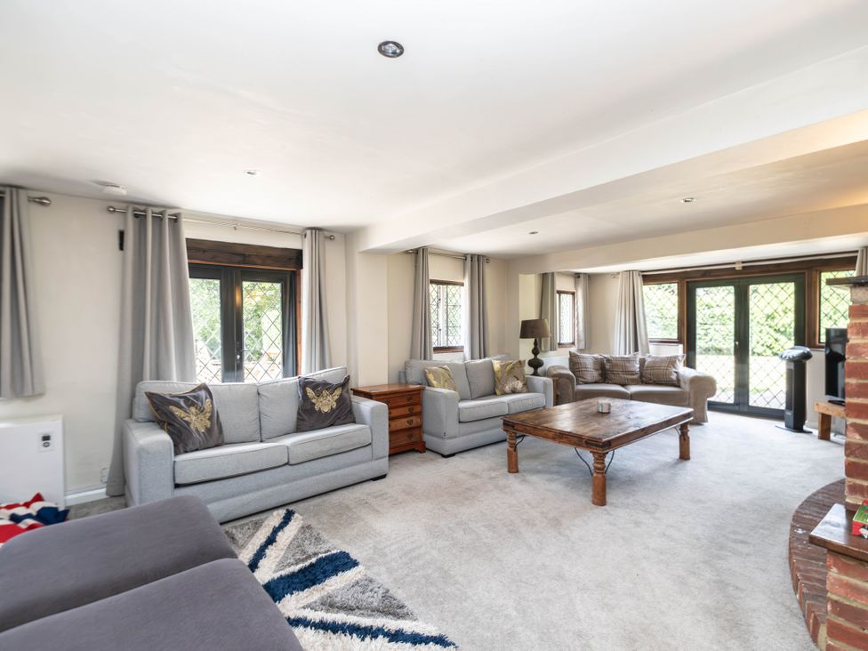 A living room with sofas and a coffee table at Gildridge in Whitesmith near East Hoathly