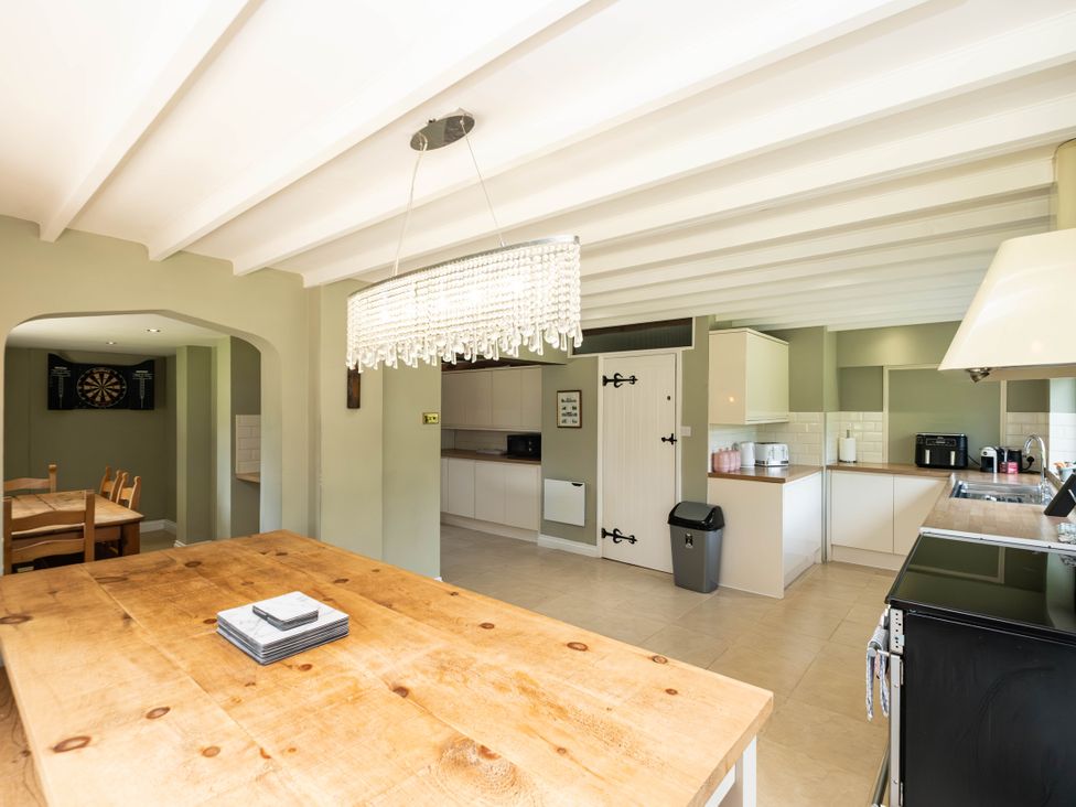 A kitchen with dining table and cabinets at Gildridge near Whitesmith East Hoathly