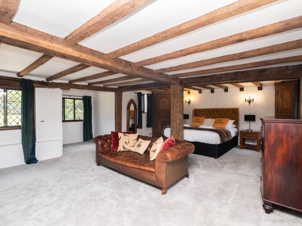 A bedroom with a bed and sofa at Gildridge in Whitesmith near East Hoathly