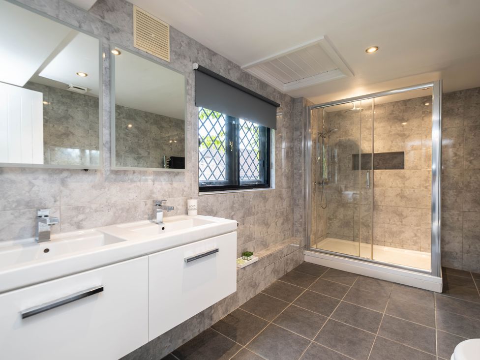 A bathroom with dual sinks and a shower at Gildridge in Whitesmith near East Hoathly