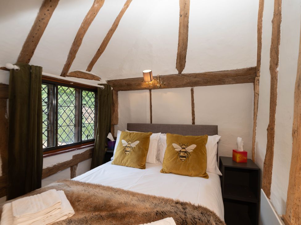 A bedroom with a bed and pillows at Gildridge in Whitesmith near East Hoathly