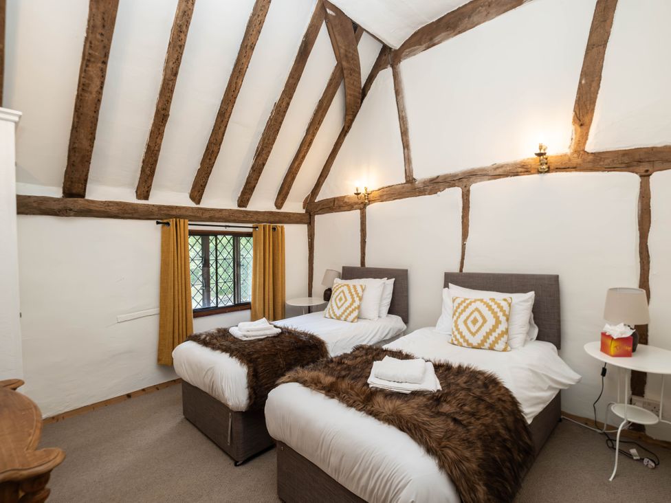 A bedroom with two beds and a window at Gildridge in Whitesmith near East Hoathly