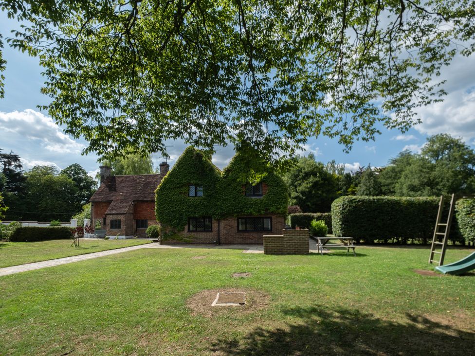 A house with green hedges and a garden at Gildridge in Whitesmith near East Hoathly