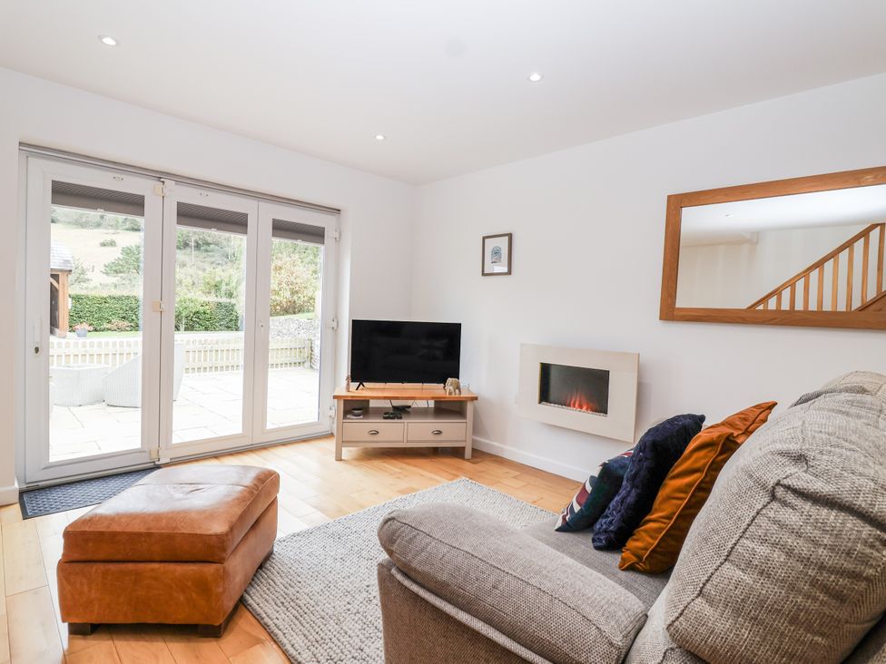 A living room with a sofa and television at Mariners Rest in Gorran Haven