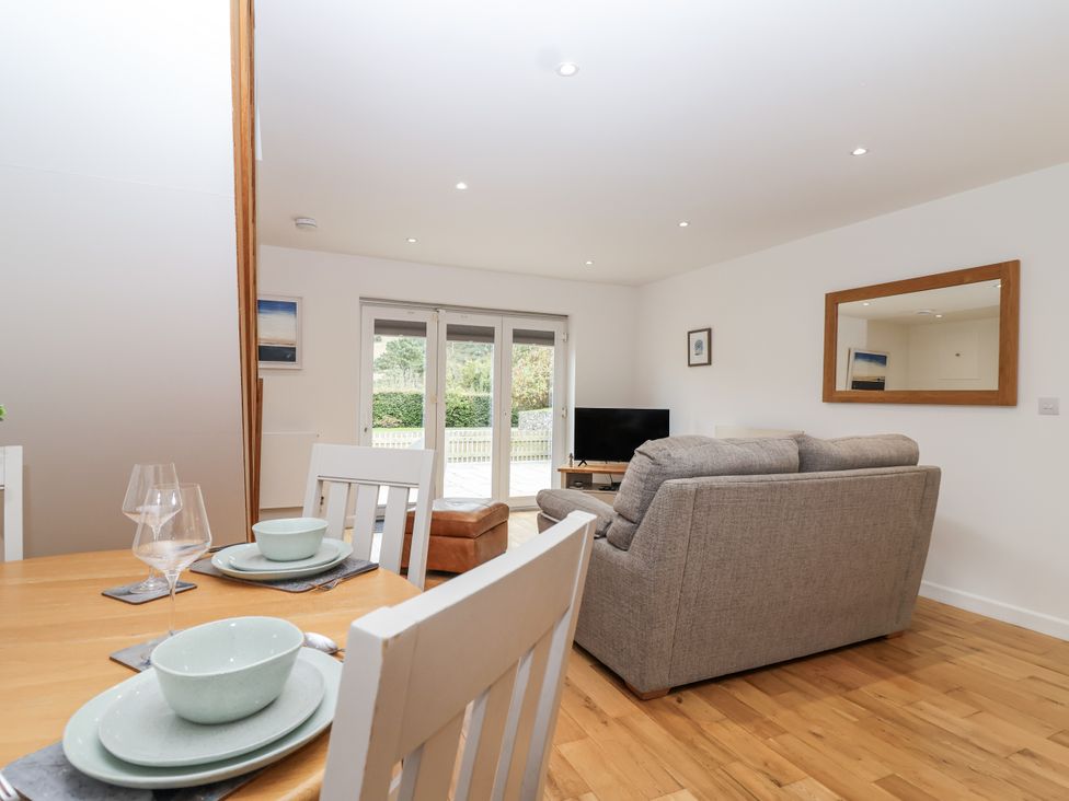 A living room with a sofa and television at Mariners Rest in Gorran Haven