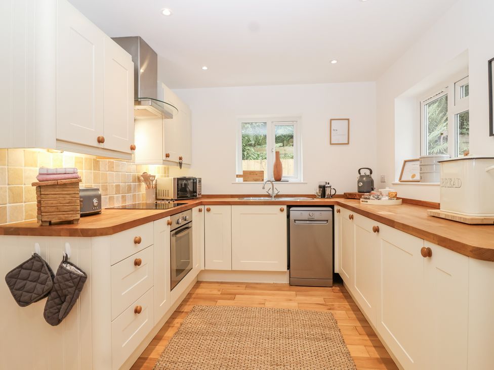 A kitchen with appliances and wooden countertops at Mariners Rest in Gorran Haven