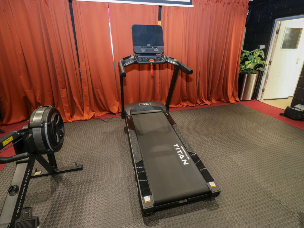 A gym with a treadmill and a rowing machine at Akila Grasscroft near Greenfield