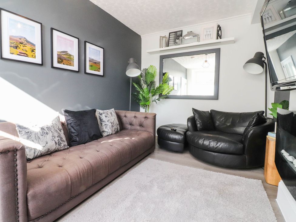 A living room with a sofa and armchair at 4 Green Street in Keighley
