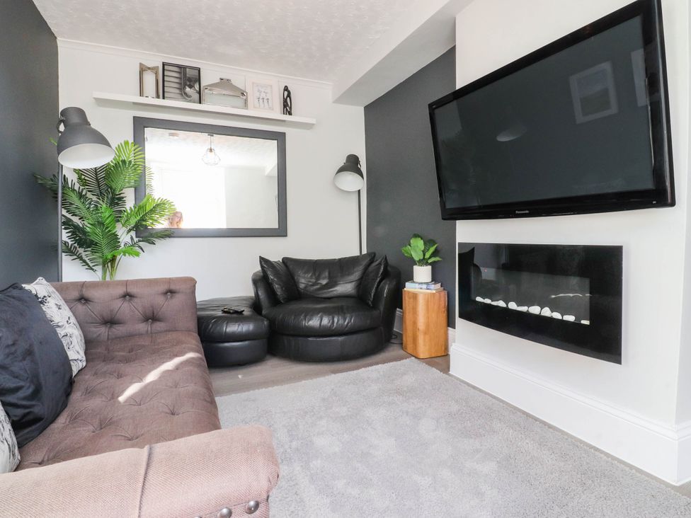 A living room with a sofa and television at 4 Green Street in Keighley