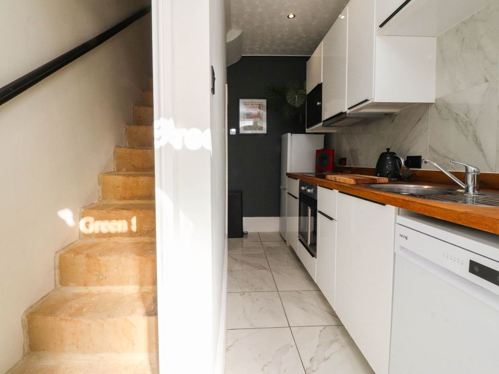 A kitchen with fridge, oven, and sink at 4 Green Street Keighley