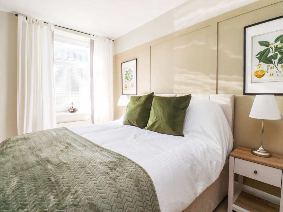 A bedroom with a bed and bedside table at 4 Green Street in Keighley