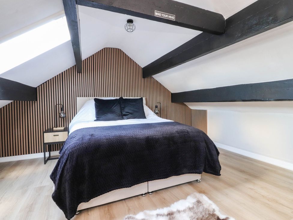 A bedroom with a bed and nightstand at 4 Green Street Keighley