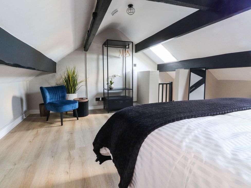 An attic bedroom with a bed and furniture at 4 Green Street in Keighley