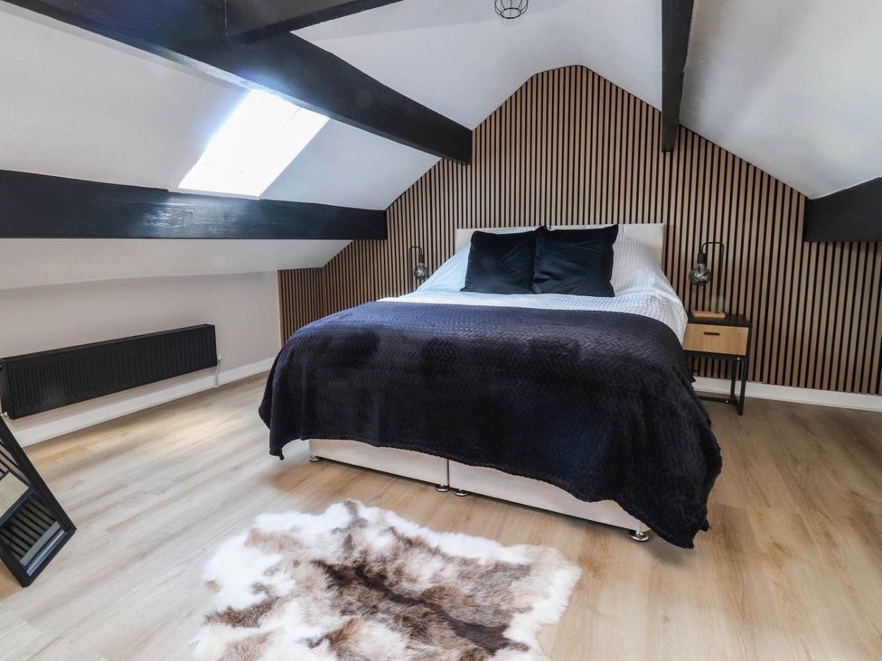 A bedroom with a bed and bedside table at 4 Green Street in Keighley