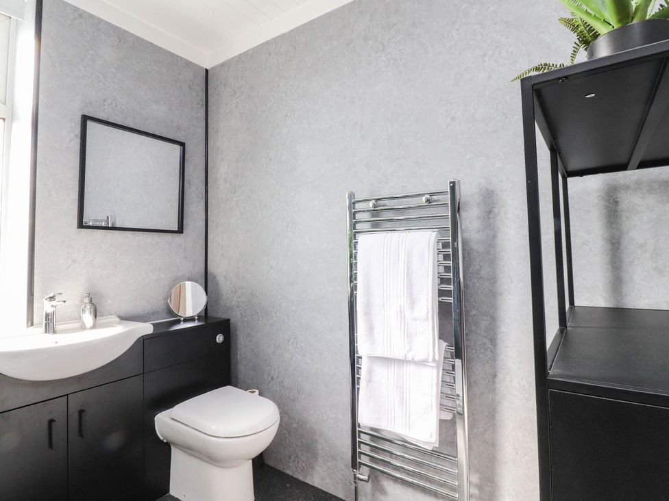 A bathroom with a sink, toilet, and towel rack at 4 Green Street in Keighley