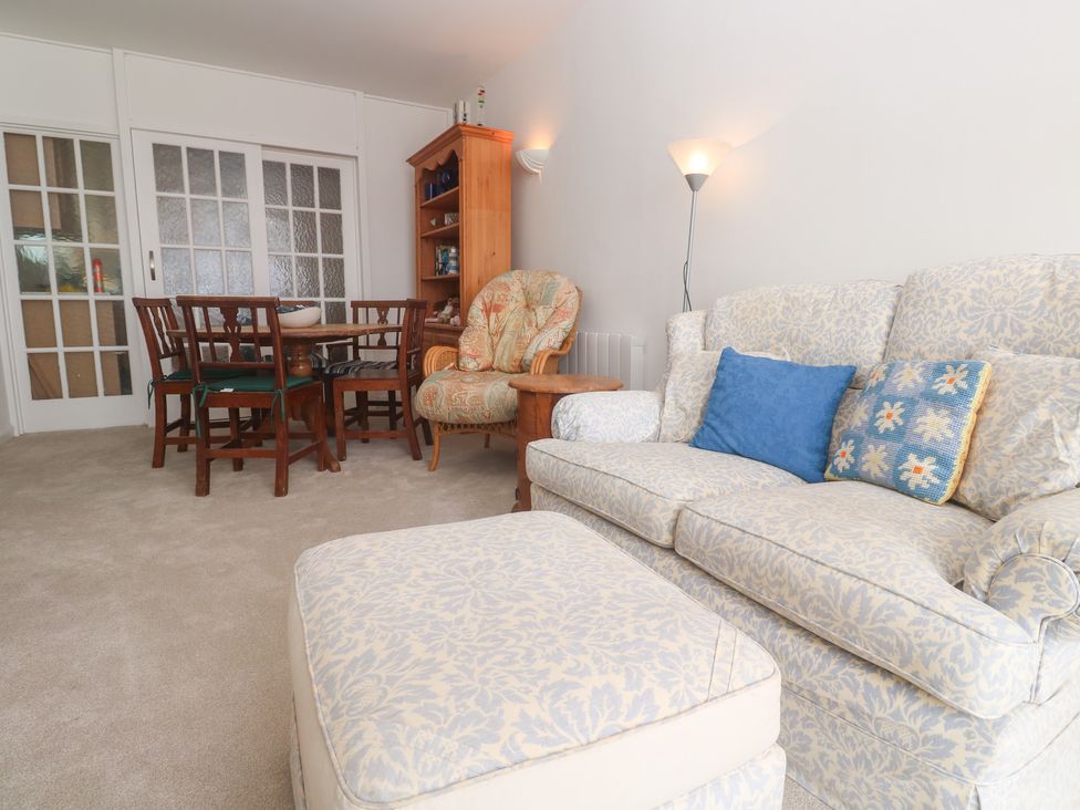 A living room with a sofa and dining table at Flat 2, Moonrakers in St. Ives