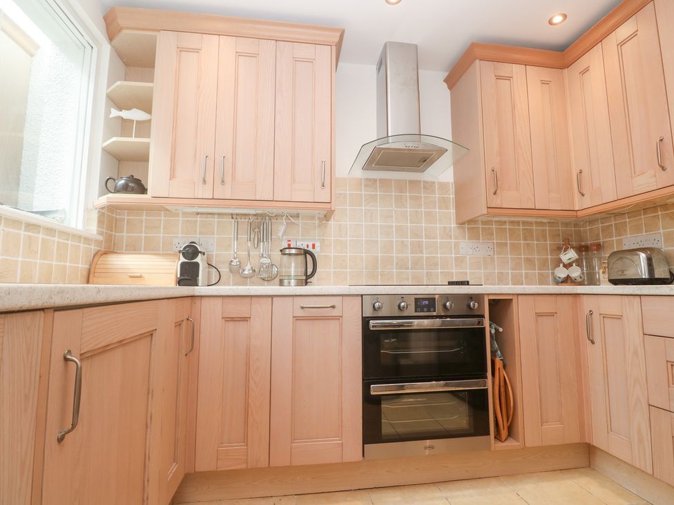 A kitchen with cabinets and appliances at Flat 2, Moonrakers in St. Ives