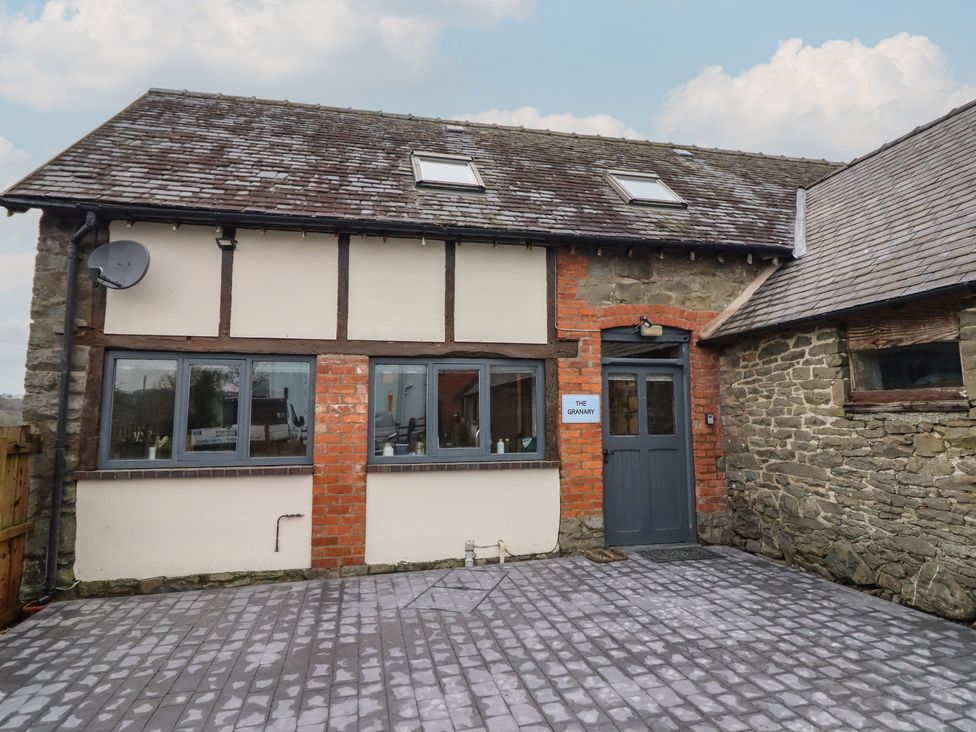 A building exterior with windows and a door at The Granary in Welshpool