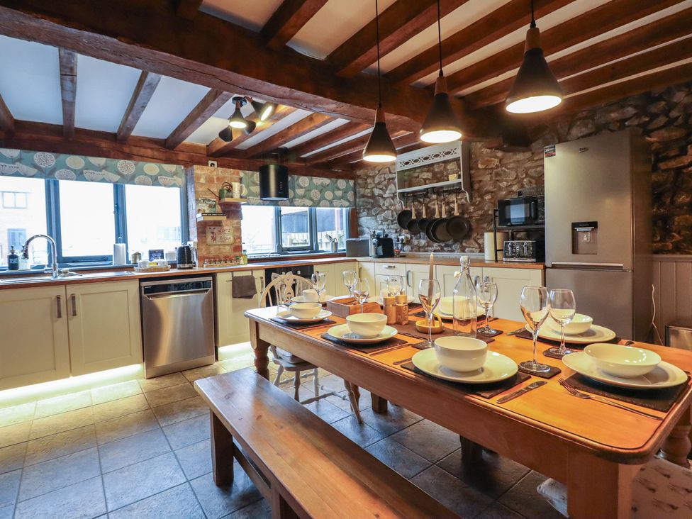 A kitchen with a dining table and chairs at The Granary in Welshpool