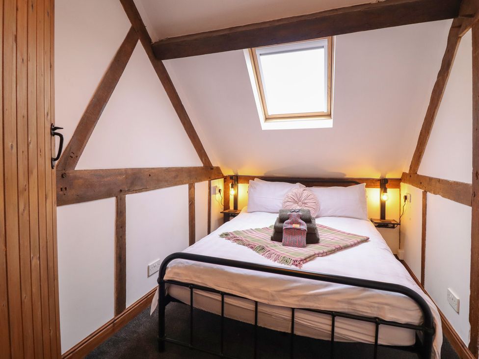 A bedroom with a bed and bedside lamps at The Granary in Welshpool