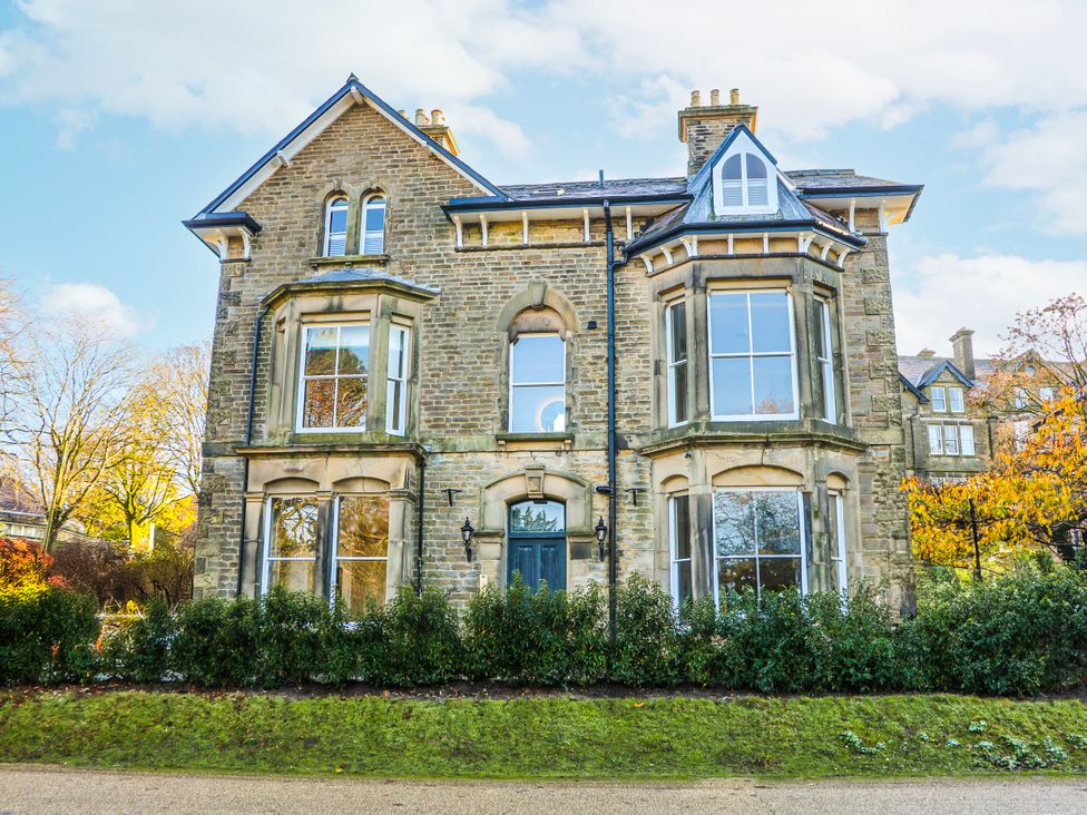 A house with large windows and a door at Castleton Suite in Buxton