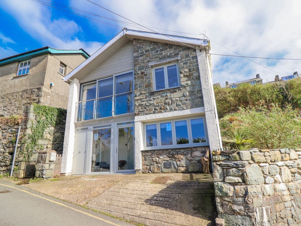 A house with stone walls and large windows at Hafod Y Bryn in Harlech