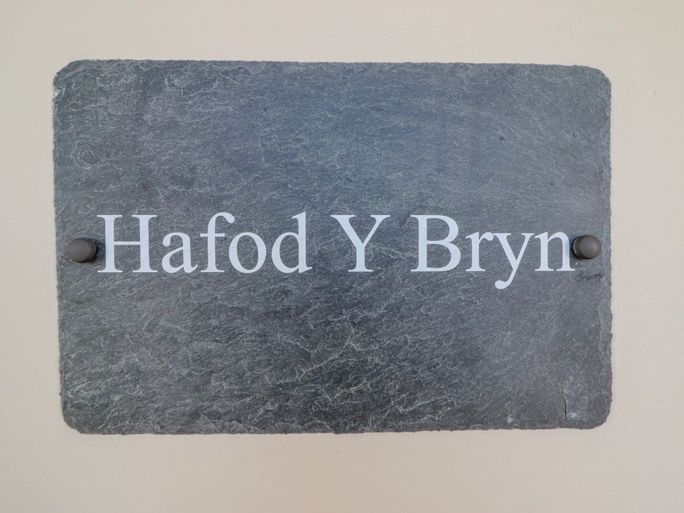 A slate sign with the text Hafod Y Bryn at Hafod Y Bryn Harlech