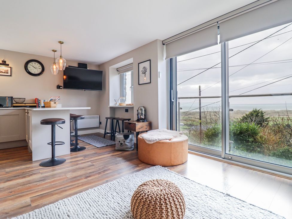 A living room with a kitchen area and a view at Hafod Y Bryn in Harlech