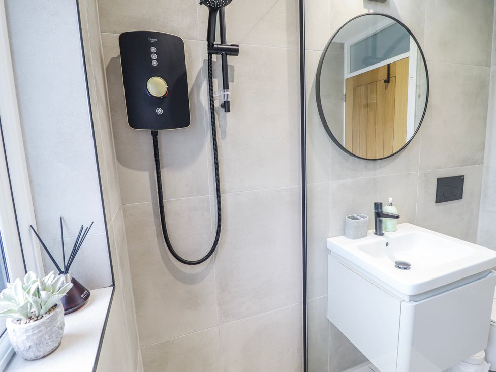 A bathroom with a shower and sink at Hafod Y Bryn in Harlech